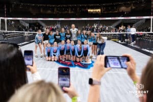 Former Nebraska head coach John Cook poses with a volleyball team there watching the match between the Supernovas and the Thirll Friday, March 28, 2025 in Omaha, Nebraska. Photo by John S. Peterson.