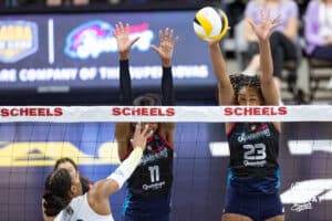 Omaha Supernovas Kelsie Payne (11) and Omaha Supernovas Kaitlyn Hord (23) jump up to block Vegas Thrill Charitie Luper (2) during a professional volleyball match Friday, March 28, 2025 in Omaha, Nebraska. Photo by John S. Peterson.