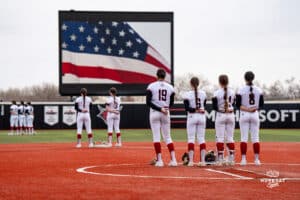 Omaha Mavericks lineup for national anthem during a softball game at Connie Clausen Field on March 22nd, 2025 in Omaha Nebraska. Photo by Collin Stilen.