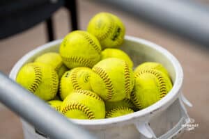 Omaha Maverick softballs in a bucket during a softball game at Connie Clausen Field on March 22nd, 2025 in Omaha Nebraska. Photo by Collin Stilen.