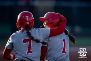 Nebraska Cornhusker Ava Kuszak (7) and Olivia DiNardo (1) celebrates the win over the Minnesota Golden Gophers during a college softball game Friday, March 21, 2025 in Lincoln, Nebraska. Photo by John S. Peterson.