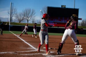 Nebraska Cornhusker Hannah Camenzind (9) scores in the first inning against Minnesota Golden Gopher catcher Taylor Krapf (13) during a college softball game Friday, March 21, 2025 in Lincoln, Nebraska. Photo by John S. Peterson.