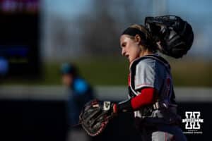Nebraska Cornhusker Ava Bredwell (24) takes off her helmet as she runs to the dugout against the Minnesota Golden Gophers during a college softball game Friday, March 21, 2025 in Lincoln, Nebraska. Photo by John S. Peterson.