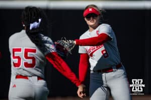 Nebraska Cornhusker Abbie Squier (8) and Dakota Carter (55) bump gloves warming up for Minnesota other during a college softball game Friday, March 21, 2025 in Lincoln, Nebraska. Photo by John S. Peterson.