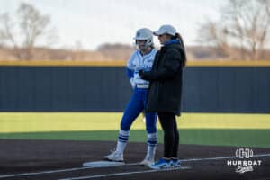 Creighton Bluejays Avery Barnard talks with a coach during a college softball game against Seattle on March 21st, 2025 in Council Bluffs, Iowa. Photo by Brandon Tiedemann.