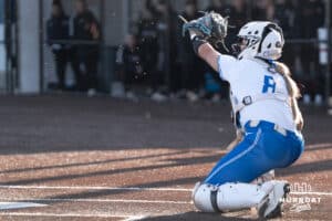 Creighton Bluejays Lily West saves a wild pitch during a college softball game against Seattle on March 21st, 2025 in Council Bluffs, Iowa. Photo by Brandon Tiedemann.