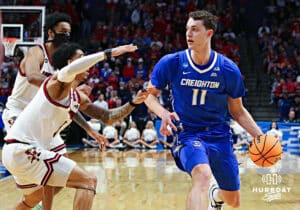 Creighton Bluejay center Ryan Kalkbrenner (11) dribbles the ball against Louisville Cardinal guard J'Vonne Hadley (1) during the first round of the NCAA Men's Basketball Tournament Thursday, March 20, 2025, Lexington, Kentucky. Photo by Jeff Moreland.