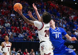 Louisville Cardinal guard Chucky Hepburn (24) goes for the rebound against Creighton Bluejay center Ryan Kalkbrenner (11) in the first half during the first round of the NCAA Men's Basketball Tournament Thursday, March 20, 2025, Lexington, Kentucky. Photo by Jeff Moreland.