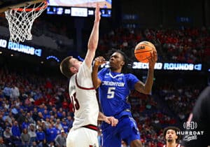 Creighton Bluejay guard Jamiya Neal (5) dirves to the basket against Louisville Cardinal forward Noah Waterman (93) in the first half during the first round of the NCAA Men's Basketball Tournament Thursday, March 20, 2025, Lexington, Kentucky. Photo by Jeff Moreland.