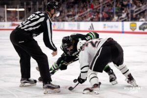 Omaha Mavericks Tyler Rollwagen faces off against North Dakota Carter Wilkie (15) during a college hockey match on March 14th, 2025, in Omaha, Nebraska. Photo by Brandon Tiedemann.