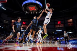 Papillion-LaVista South Titan Bryson Bahl (20) makes a jumpshot against Millar North Mustang Amari Rahaman (11) during the semi-finals of the NSAA Boys State Championships Friday, March 14, 2025. Photo by Mac Johnson.
