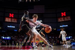 Lincoln North Star Gator William Schafer (12) dribbles the ball against Lincoln Southeast Knight Chiang Thoat (33) during the quarter-finals of the NSAA Boys State Championships Wednesday, March 12, 2025. Photo by Mac Johnson.