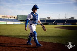 Creighton Bluejay catcher Nate McHugh (5) walking to the dugout to take on the South Dakota State Jackrabbits during a college baseball game Tuesday, March 18, 2025 in Omaha, Nebraska. Photo by John S. Peterson.