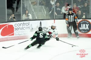 Omaha Mavericks Myles Hilman looks to pass during a college hockey game against North Dakota on March 15th, 2025 in Omaha Nebraska. Photo by Brandon Tiedemann.