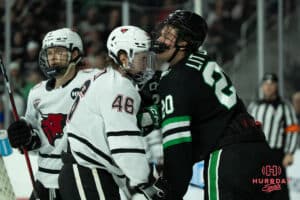 Omaha Mavericks Dylan Gratton pushes an opponent during a college hockey game against North Dakota on March 15th, 2025 in Omaha Nebraska. Photo by Brandon Tiedemann.