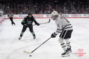Omaha Mavericks Zach Urdahl looks to pass during a college hockey game against North Dakota on March 15th, 2025 in Omaha Nebraska. Photo by Brandon Tiedemann.