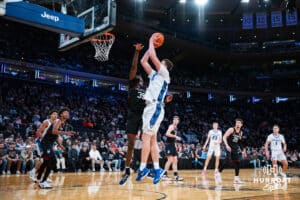 Creighton Bluejay center Ryan Kalkbrenner (11) makes a lay up against Connecticut Husky center Samson Johnson (35) during the semi-final round in the Big East Tournament Friday, March 14, 2025, New York, New York. Photo by Jordan Arnold.