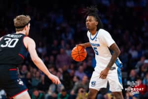 Creighton Bluejay guard Jamiya Neal (5) dribbles the ball against Connecticut Husky forward Liam McNeeley (30) during the semi-final round in the Big East Tournament Friday, March 14, 2025, New York, New York. Photo by Jordan Arnold.