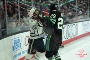 Omaha Mavericks Jacob Guevin gets hit in the face during a college hockey game against North Dakota on March 14th, 2025 in Omaha Nebraska. Photo by Brandon Tiedemann.