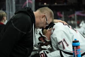 Omaha Mavericks Tanner Ludtke prays before a college hockey game against North Dakota on March 14th, 2025 in Omaha Nebraska. Photo by Brandon Tiedemann.