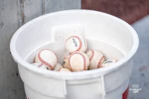 A bucket of baseballs ready for use during a baseball game at Tal Anderson Field on March 12th, 2025 in Omaha Nebraska. Photo by Collin Stilen.