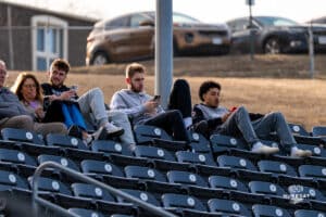 Omaha Mavericks basketball players Tony Osburn, Joshua Streit and Lance Waddles during the seventh inning stretch during a baseball game at Tal Anderson Field on March 12th, 2025 in Omaha Nebraska. Photo by Collin Stilen.