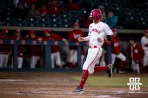Nebraska Cornhusker Jaron Cotton (21) scores in the eighth inning against the Wichita St. Shockers during a college baseball game Tuesday, March 11, 2025 in Lincoln, Nebraska. Photo by John S. Peterson.