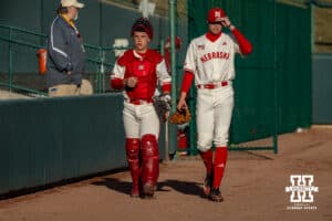Nebraska Cornhusker pitcher Carson Jasa (39) and catcher Will Jesske (13) walk to the dugout for the start of the game against the Wichita St. Shockers during a college baseball game Tuesday, March 11, 2025 in Lincoln, Nebraska. Photo by John S. Peterson.