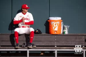Nebraska Cornhusker pitcher Blake Encarnacion (23) sits on the bench in the bull pen waiting to get started warming up for Wichita St. Shockers during a college baseball game Tuesday, March 11, 2025 in Lincoln, Nebraska. Photo by John S. Peterson.