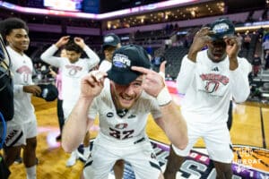 Omaha Maverick guard Tony Osburn (32) shows off the championship hat after the win over the St. Thomas Tommies during the Summit League Tournament Finals Sunday, March 9, 2025 in Sioux Falls, South Dakota. Photo by John S. Peterson.