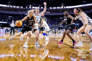 Omaha Maverick guard Grace Cave (20) drives to the basket against South Dakota State Jackrabbit guard Emilee Fox (4) during the Summit League Tournament Tuesday, March 4, 2025 in Lincoln, Nebraska. Photo by John S. Peterson.