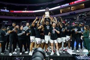 Omaha Mavericks hold the Summit League championship trophy up after the win over the St. Thomas Tommies during the finals Sunday, March 9, 2025 in Sioux Falls, South Dakota. Photo by John S. Peterson.
