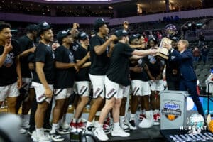 Omaha Mavericks receive the championship trophy from the league commissioner Josh Fenton after the win over the St. Thomas Tommies during the Summit League Tournament Finals Sunday, March 9, 2025 in Sioux Falls, South Dakota. Photo by John S. Peterson.