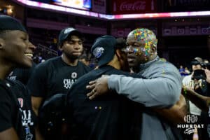 Omaha Maverick head coach Chris Cruchfield hugs players after having a bucket of confetti dumped on him after the win over the St. Thomas Tommies during the Summit League Tournament Finals Sunday, March 9, 2025 in Sioux Falls, South Dakota. Photo by John S. Peterson.