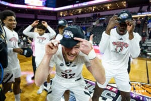Omaha Maverick guard Tony Osburn (32) shows off the championship hat after the win over the St. Thomas Tommies during the Summit League Tournament Finals Sunday, March 9, 2025 in Sioux Falls, South Dakota. Photo by John S. Peterson.