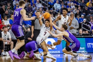 Omaha Maverick guard Lance Waddles (7) battles to keep the ball against the St. Thomas Tommies in the second half during the Summit League Tournament Finals Sunday, March 9, 2025 in Sioux Falls, South Dakota. Photo by John S. Peterson.