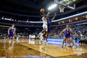 Omaha Maverick guard JJ White (1) makes a lay up against St. Thomas Tommies guard Kendall Blue (1) in the first half during the Summit League Tournament Sunday, March 9, 2025 in Sioux Falls, South Dakota. Photo by John S. Peterson.