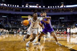 Omaha Maverick guard JJ White (1) drives to the basket against St. Thomas Tommies guard Kendall Blue (1) in the first half during the Summit League Tournament Finals Sunday, March 9, 2025 in Sioux Falls, South Dakota. Photo by John S. Peterson.