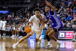 Omaha Maverick guard Lance Waddles (7) dribbles the ball against St. Thomas Tommies guard Kendall Blue (1) in the first half during the Summit League Tournament Finals Sunday, March 9, 2025 in Sioux Falls, South Dakota. Photo by John S. Peterson.