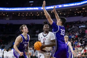 Omaha Maverick guard JJ White (1) drives to the basket for a lay up against St. Thomas Tommies forward Rich Byhre (33) in the first half during the Summit League Tournament Finals Sunday, March 9, 2025 in Sioux Falls, South Dakota. Photo by John S. Peterson.