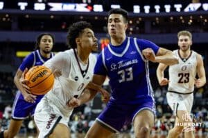 Omaha Maverick guard Lance Waddles (7) drives to the basket against St. Thomas Tommies forward Rich Byhre (33) in the first half during the Summit League Tournament Finals Sunday, March 9, 2025 in Sioux Falls, South Dakota. Photo by John S. Peterson.
