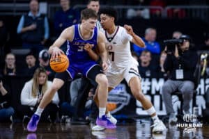 Omaha Maverick guard Lance Waddles (7) defends against St. Thomas Tommies guard Ben Oosterbaan (34) in the first half during the Summit League Tournament Sunday, March 9, 2025 in Sioux Falls, South Dakota. Photo by John S. Peterson.