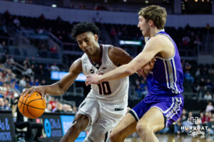 Omaha Maverick forward Marquel Sutton (10) drives to the basket against St. Thomas Tommies guard Nolan Minessale (4) in the first half during the Summit League Tournament Finals Sunday, March 9, 2025 in Sioux Falls, South Dakota. Photo by John S. Peterson.