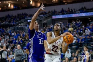 Omaha Maverick forward Kamryn Thomas (22) makes a lay up against St. Thomas Tommies forward Rich Byhre (33) in the first half during the Summit League Tournament Finals Sunday, March 9, 2025 in Sioux Falls, South Dakota. Photo by John S. Peterson.