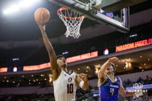 Omaha Maverick forward Marquel Sutton (10) makes a lay up against St. Thomas Tommies guard Nolan Minessale (4) in the first half during the Summit League Tournament Finals Sunday, March 9, 2025 in Sioux Falls, South Dakota. Photo by John S. Peterson.
