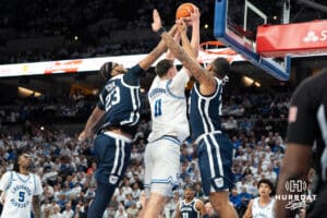 Creighton Bluejays Ryan Kalkbrenner dunks on two defenders during a college basketball game against Butler on March 8th, 2025 in Omaha Nebraska. Photo by Brandon Tiedemann.