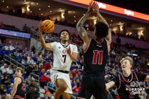 Nebraska-Omaha Maverick guard Lance Waddles (7) makes a lay up against South Dakota Coyote guard Dre Bullock (11) in the second half during the Summit League Tournament Saturday, March 8, 2025 in Sioux Falls, South Dakota. Photo by John S. Peterson.