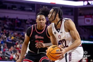 Nebraska-Omaha Maverick forward Kamryn Thomas (22) drives to the basket against South Dakota Coyote forward Ashton Smith (32) during the Summit League Tournament Saturday, March 8, 2025 in Sioux Falls, South Dakota. Photo by John S. Peterson.
