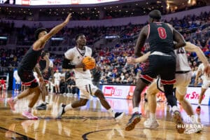 Nebraska-Omaha Maverick guard Ja'Sean Glover (5) drives to the basket against the South Dakota Coyotes in the first half during the Summit League Tournament Saturday, March 8, 2025 in Sioux Falls, South Dakota. Photo by John S. Peterson.