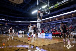 Nebraska-Omaha Maverick forward Kamryn Thomas (22) makes a basket against South Dakota Coyote guard Max Burchill (3) in the in the first half during the Summit League Tournament Saturday, March 8, 2025 in Sioux Falls, South Dakota. Photo by John S. Peterson.
